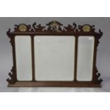 An Edwardian mahogany overmantel mirror, the fretwork frieze with a carved and gilded phoenix and