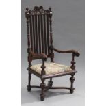 A late 19th century Carolean Revival oak rail back carver chair, the top rail carved with leaf