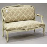 An early/mid-20th century French Louis XV style cream painted showframe settee, raised on cabriole