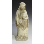 A Medieval carved stone figure of a standing saint, faint traces of coloured pigment remaining,