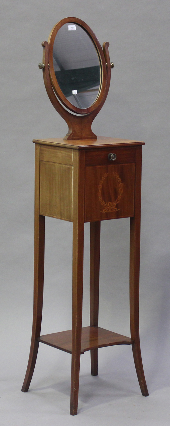 An Edwardian mahogany shaving stand with satinwood stringing, the oval swing frame mirror above a