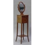 An Edwardian mahogany shaving stand with satinwood stringing, the oval swing frame mirror above a