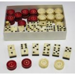 A group of ebony and bone dominoes and a set of bone draught counters.Buyer’s Premium 29.4% (