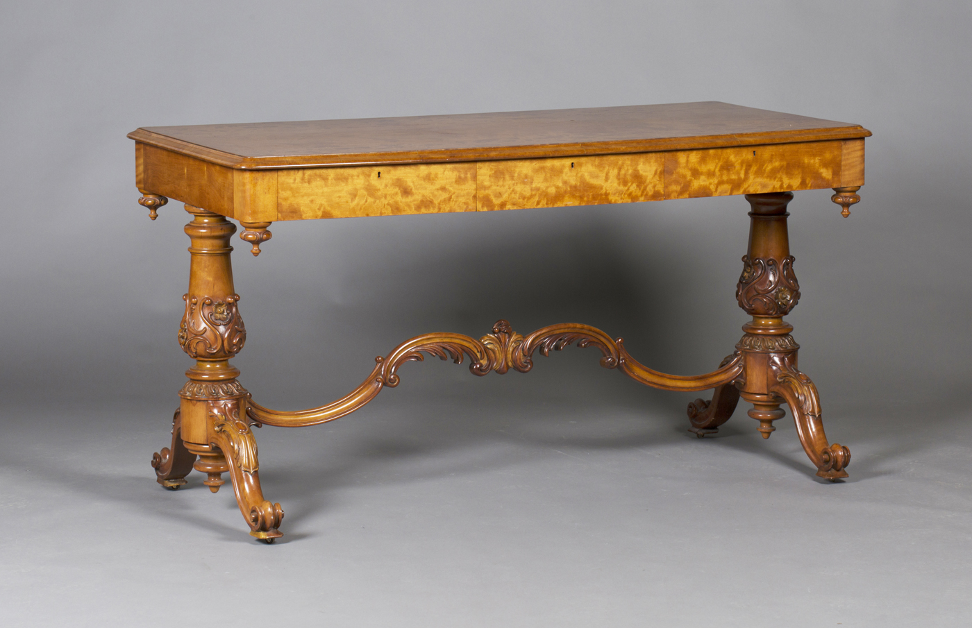 A mid-Victorian satinwood rectangular centre table, fitted with three concealed drawers, the twin