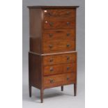 An early 20th century mahogany chest-on-chest, fitted with seven drawers, on square tapering legs,