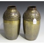A pair of early 20th century WMF anodized brass vases, embossed with bands of leaves and flowers,