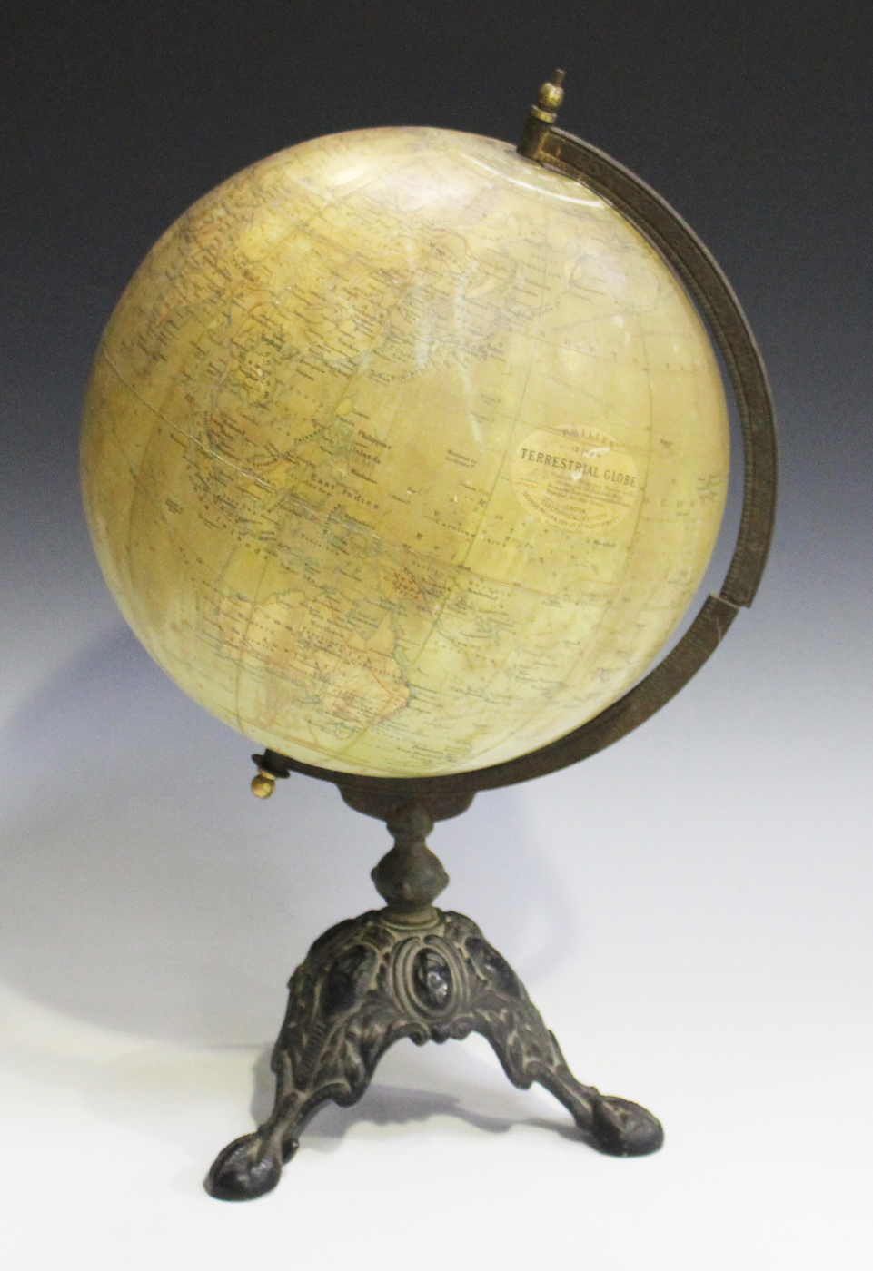 An early 20th century 'Philips' 12 inch Terrestrial Globe', raised on a cast iron foliate base