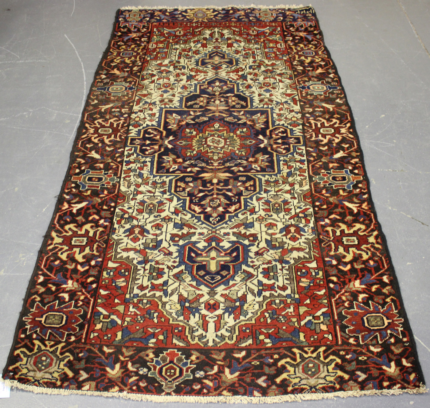 A Bakhtiari rug, North-west Persia, early 20th century, the ivory field with a shaped ink blue