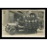 A photographic postcard of the Worthing fire brigade with their engine outside the fire station on