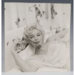 BEATON, Cecil. A black and white photograph of Marilyn Monroe holding a carnation, 22.5cm x 21cm, '