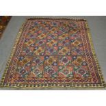 A Kurdish rug, early 20th century, the compartmentalized polychrome field enclosing hooked guls,