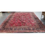 A Mashad carpet, Central Persia, mid-20th century, the pale claret field with an overall design of