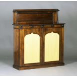 A Regency rosewood chiffonier, the shelf back above a pair of panel doors inset with fabric