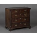 A George III mahogany chest of two short and three long graduated drawers, fitted with a brushing