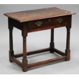 An 18th century oak side table, fitted with a drawer, on turned and block legs united by stretchers,