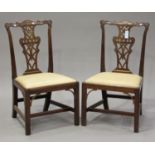 A pair of George III Chippendale period mahogany pierced splat back dining chairs with carved