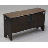 A 17th century oak six plank coffer, the interior fitted with a candle box, raised on shaped side