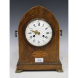 An Edwardian rosewood mantel clock with eight day movement striking on a gong, the circular enamel