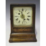 A late 19th century German walnut mantel alarm clock, striking on a bell, the backplate stamped 'W &