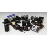 A collection of cameras and accessories, including three Pentax Spotmatic camera bodies, a Zenit