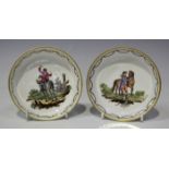 A pair of Höchst porcelain equestrian circular dishes, late 18th century, each painted with a figure