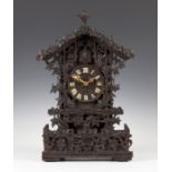 A late 19th century Black Forest carved oak mantel cuckoo clock with two train movement striking