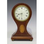 An Edwardian mahogany mantel timepiece, the dial with Roman numerals, the case of balloon form, on