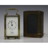 An early 20th century French lacquered brass carriage alarm clock with eight day movement striking