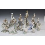 Thirteen Lladro porcelain figures, including Friendship, No. 1230, Girl feeding Rabbit, No. 4826,