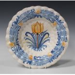 A Dutch delft pleated dish, circa 1690, moulded with two rows of flutes around a circular foot,