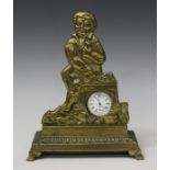 A Victorian brass pocket watch stand, cast in the form of a seated figure, on a rectangular base and