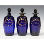 A set of three Bristol blue decanters and stoppers, late 18th/early 19th century, each of barrel