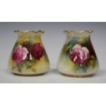 A matched pair of Royal Worcester porcelain vases, circa 1914 and 1923, each wavy rim and ovoid body