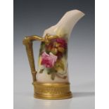 A Royal Worcester bone china jug, circa 1918, of tusk form with gilt antler textured handle, the