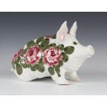 A large Wemyss pottery pig, modelled seated on its haunches, painted with pink roses and green