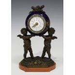 A late 19th/early 20th century French bronze and porcelain desk timepiece, the movement with