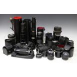 A large collection of camera lenses, including two Vivitar 28-200mm 1:3.5-5.3 macro focusing zoom