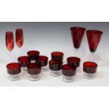 A collection of red tinted glassware, 20th century, including a set of eighteen French circular