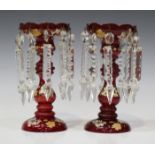 A pair of ruby glass table lustres, late 19th century, each circular top with lobed rim, on a