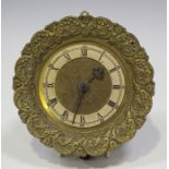 An early 20th century brass cased circular wall clock, the silvered chapter ring with black Roman