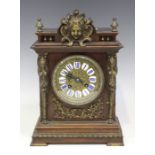 A late 19th century French brass mounted walnut mantel clock with eight day movement striking on a