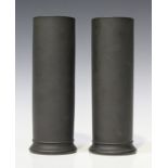 A pair of Wedgwood black basalt cylindrical vases, circa 1890, impressed marks to base, height 24.