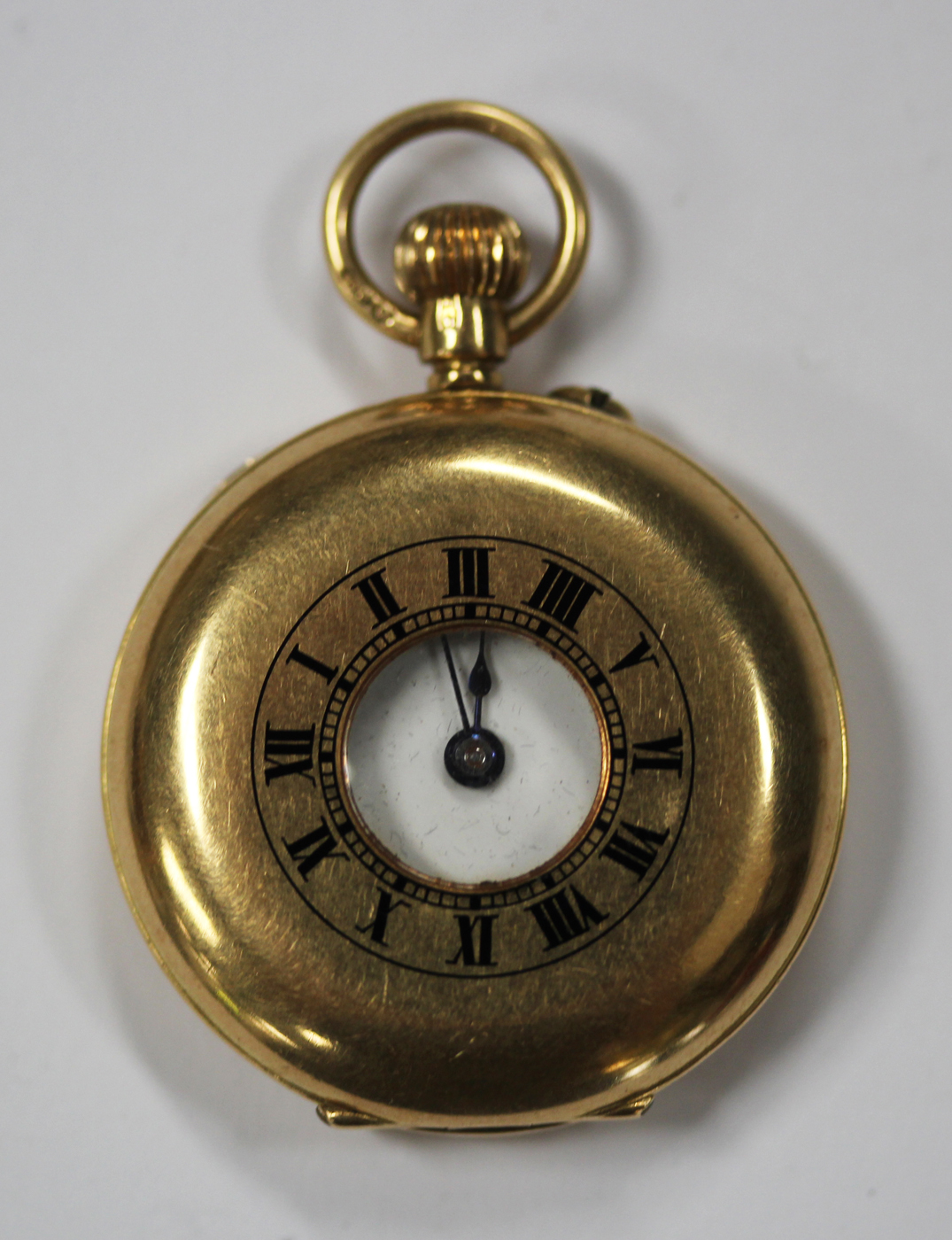 An 18ct gold keyless wind half-hunting cased lady's fob watch, with a gilt jewelled movement, 18ct