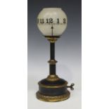 A late 19th century/early 20th century French brass night clock timepiece, the frosted glass shade