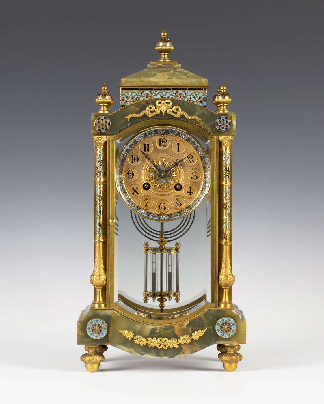 A late 19th century French gilt brass, champlevé enamel and onyx four glass mantel clock with