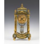 A late 19th century French gilt brass, champlevé enamel and onyx four glass mantel clock with