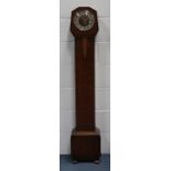An Art Deco oak diminutive longcase clock, the eight day movement with Westminster chime on gongs,