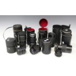 A group of eight camera lenses, including a Sigma 1:4.5-5.6 f=75-300mm zoom lens, Tamron 35-210mm