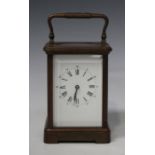 An early 20th century French brass cased carriage clock with eight day movement striking on a