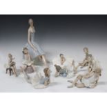 A Lladro porcelain figure of a ballerina seated on a rock, No. 4559, and three other Lladro